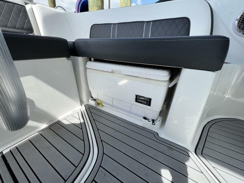 Interior of 2022 Monterey M-45 boat with built-in cooler and cushioned seating.