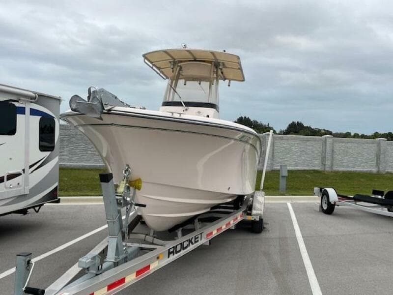 2014 Grady-White Fisherman 257 boat on a trailer in a parking lot.