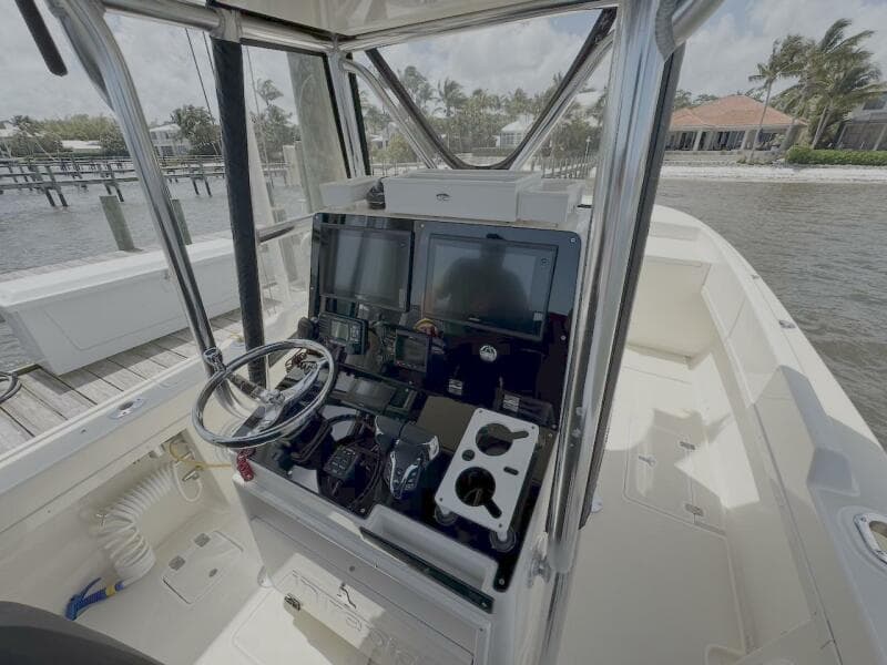 2004 Intrepid 32 Cuddy boat cockpit with steering wheel and navigation equipment.