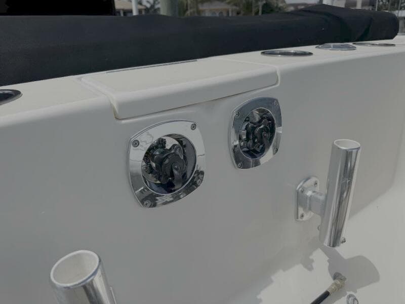 2004 Intrepid 32 Cuddy boat deck with chrome fittings and rod holders.