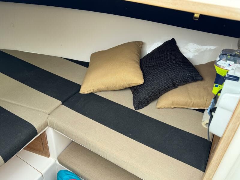 Interior cabin of a 2004 Intrepid 32 Cuddy boat with cushions and pillows.