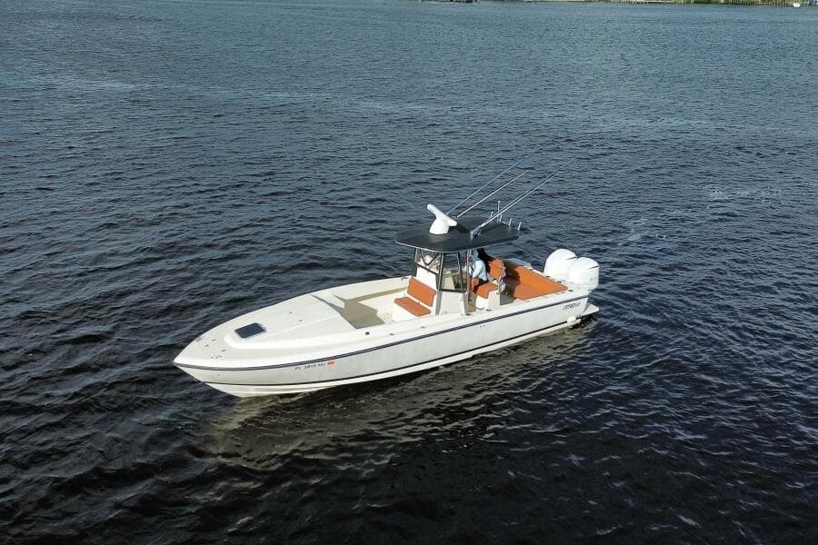 2004 Intrepid 32 Cuddy boat cruising on open water.