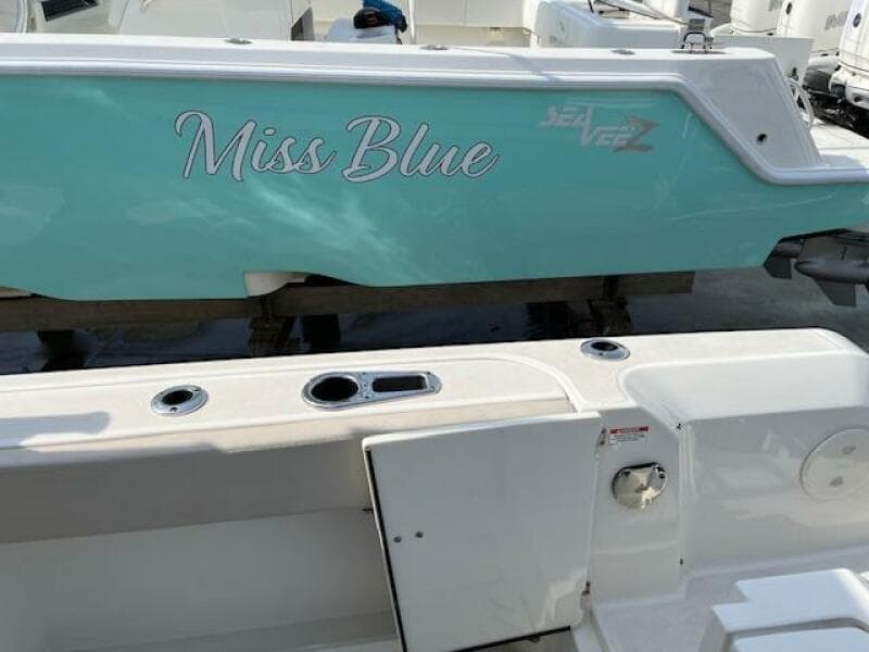 2018 Boston Whaler 270 Vantage Miss Blue boat docked, showing side and deck.
