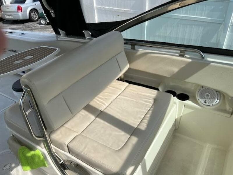 2018 Boston Whaler 270 Vantage boat interior with white cushioned seating and cup holders.