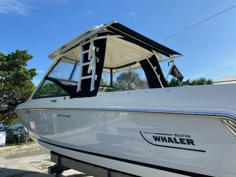 2018 Boston Whaler 270 Vantage boat on a trailer under a clear blue sky.