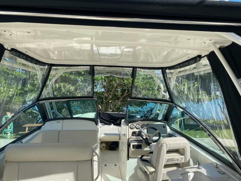 Interior view of 2018 Boston Whaler 270 Vantage boat with clear canopy and seating.