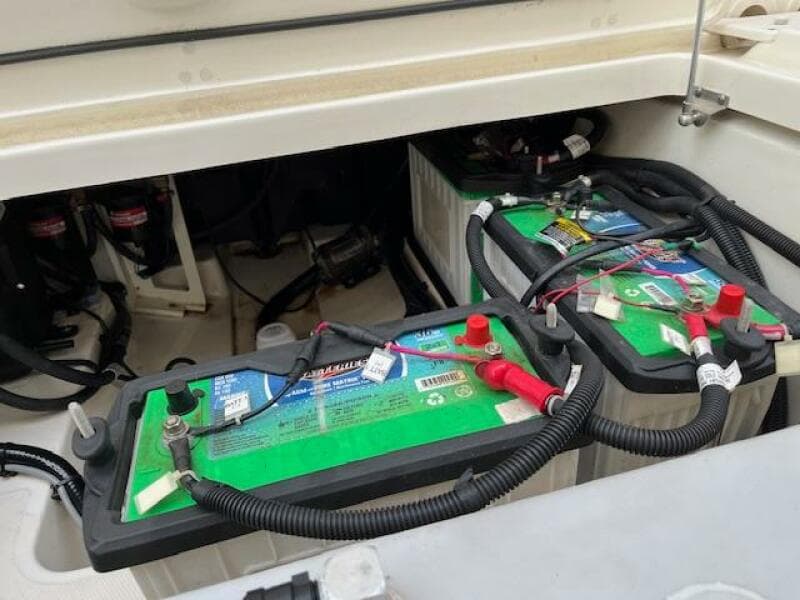 2018 Boston Whaler 270 Vantage boat battery compartment with two green batteries.