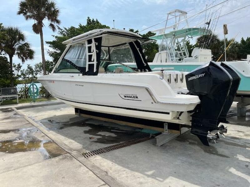 2018 Boston Whaler 270 Vantage boat on a dock with Mercury outboard engines.