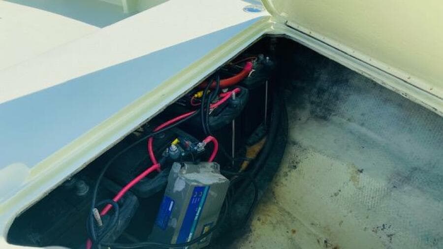 Battery compartment of a 1983 Maverick 18 Flats Boat with wiring and connections.