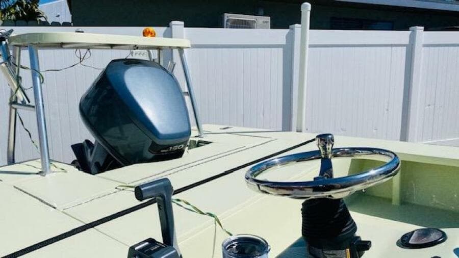 1983 Maverick 18 Flats Boat with outboard motor and steering wheel.