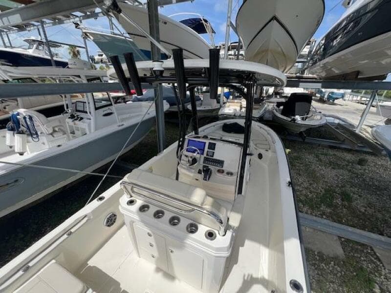 2023 Boston Whaler 250 Dauntless boat in storage, featuring a sleek console and seating area.