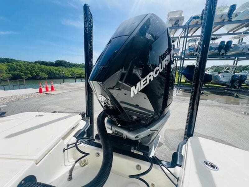 2023 Boston Whaler 250 Dauntless with Mercury outboard engine, docked near water.
