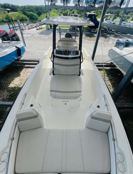 2023 Boston Whaler 250 Dauntless boat, sleek design, spacious seating, docked outdoors.