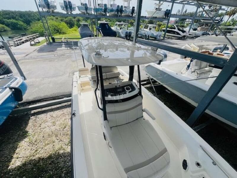 2023 Boston Whaler 250 Dauntless boat in storage, featuring sleek design and spacious deck.
