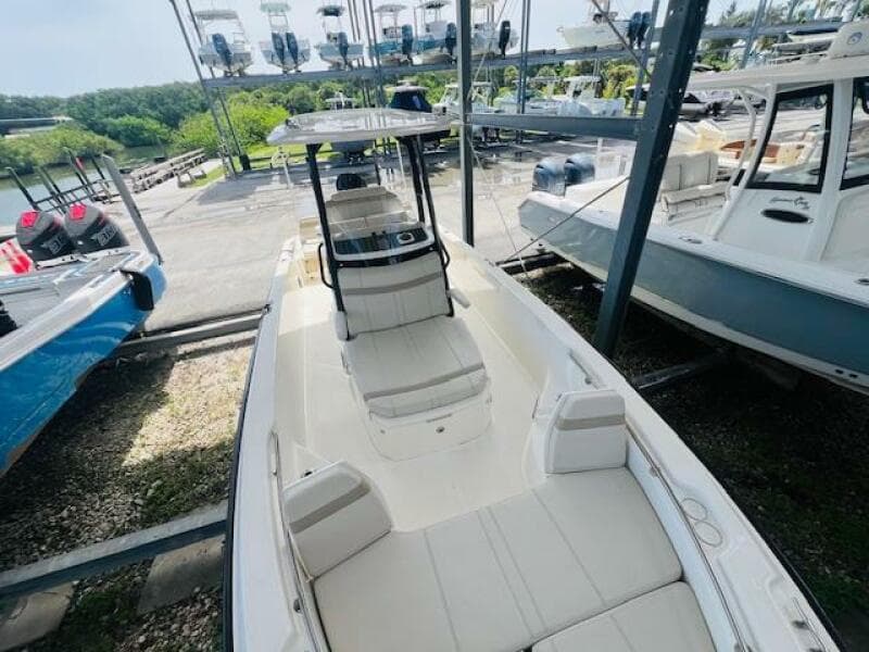 2023 Boston Whaler 250 Dauntless boat in storage, showcasing sleek design and spacious seating.