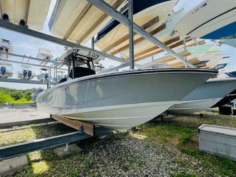 2023 Boston Whaler 250 Dauntless boat on storage rack, side view.