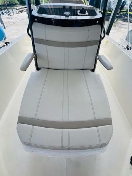 2023 Boston Whaler 250 Dauntless boat seat with armrests, white and gray upholstery.