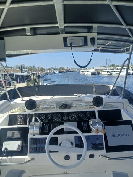 1997 Sea Ray 550 Sedan Bridge helm with Garmin navigation, docked at marina.