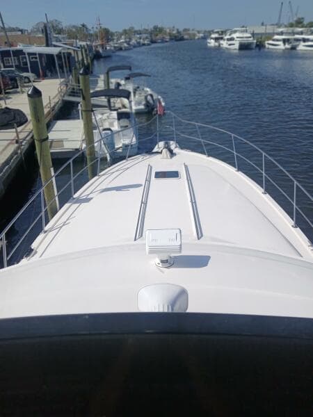 1997 Sea Ray 550 Sedan Bridge yacht docked in a marina, view from the bow.