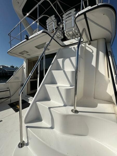 Staircase on a 1997 Sea Ray 550 Sedan Bridge yacht leading to the upper deck.