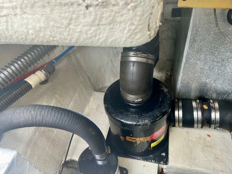 Engine compartment of a 2003 Regal Commodore 3860 boat showing hoses and fittings.