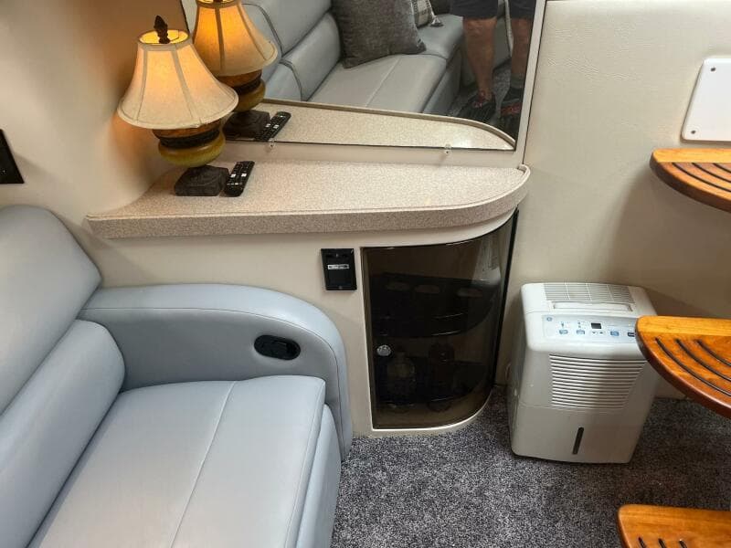 Interior of 2003 Regal Commodore 3860 with seating, lamps, and dehumidifier.