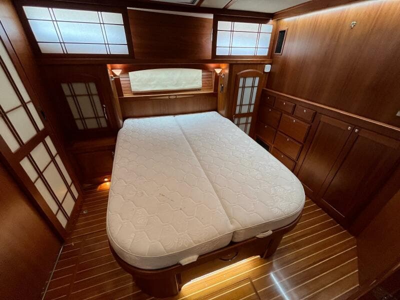 Luxurious 2013 Sabre 48 Salon Express cabin with elegant wood finish and comfortable bed.