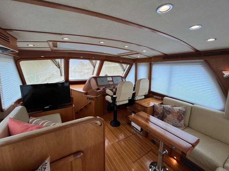 Luxurious interior of 2013 Sabre 48 Salon Express yacht with wood finish and seating.