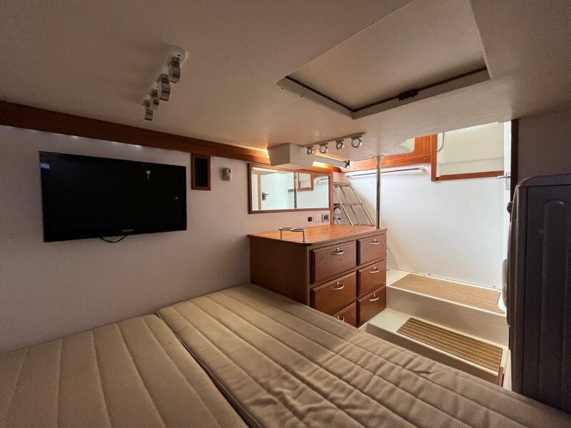 Interior of 2013 Sabre 48 Salon Express with bed, TV, and stairs.