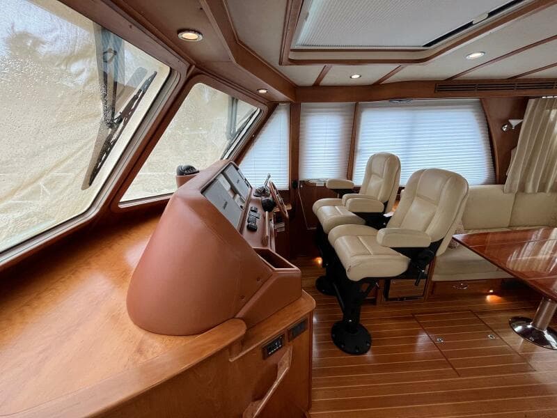 Interior of 2013 Sabre 48 Salon Express yacht with leather seats and wooden flooring.