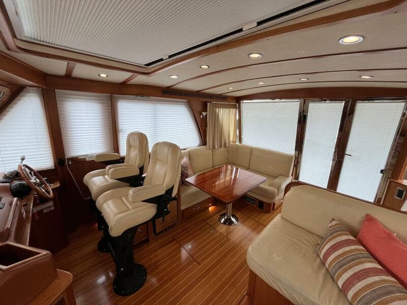 Interior of 2013 Sabre 48 Salon Express yacht with plush seating and wooden accents.