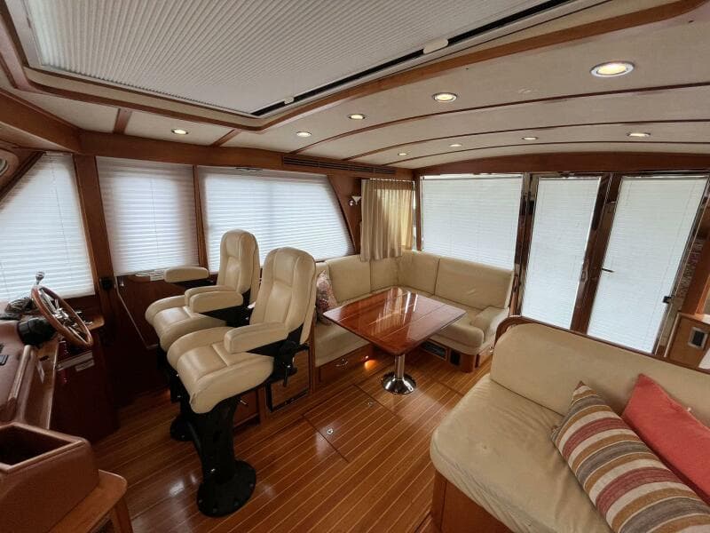 Interior of 2013 Sabre 48 Salon Express yacht with plush seating and wooden accents.