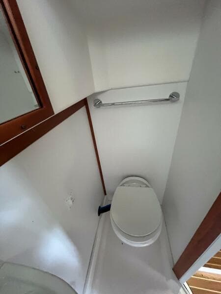 2013 Sabre 48 Salon Express bathroom with toilet and towel rack.