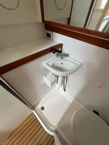 Compact bathroom in 2013 Sabre 48 Salon Express yacht with sink and shower.