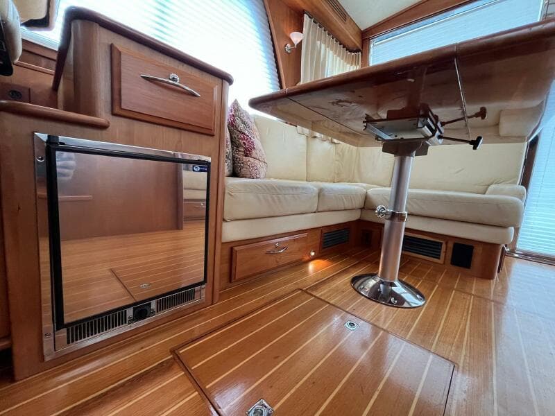 Interior of 2013 Sabre 48 Salon Express with wood flooring and seating area.