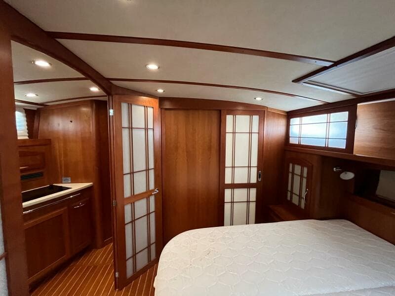 Luxurious 2013 Sabre 48 Salon Express interior with wood finish and cozy bedroom.