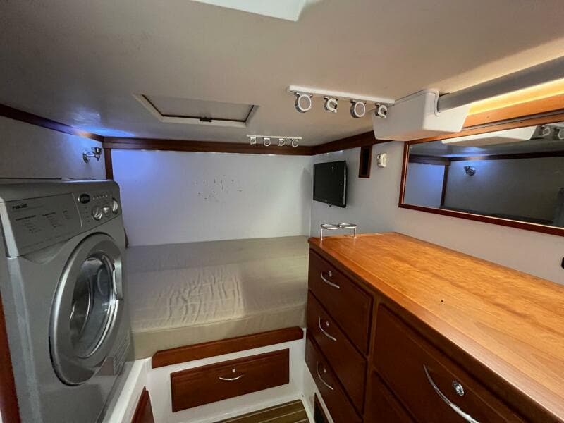 Interior of 2013 Sabre 48 Salon Express with bed, washer, and wooden cabinetry.