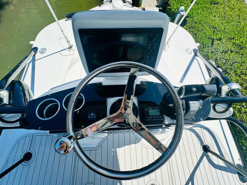 2000 Luhrs Tournament 320 Open boat helm with steering wheel and navigation equipment.
