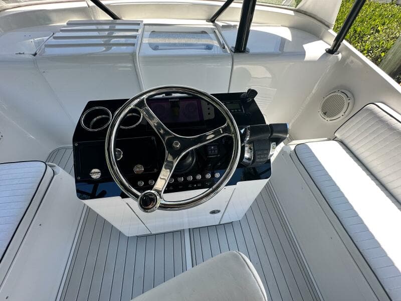 2000 Luhrs Tournament 320 Open boat helm with steering wheel and seating.