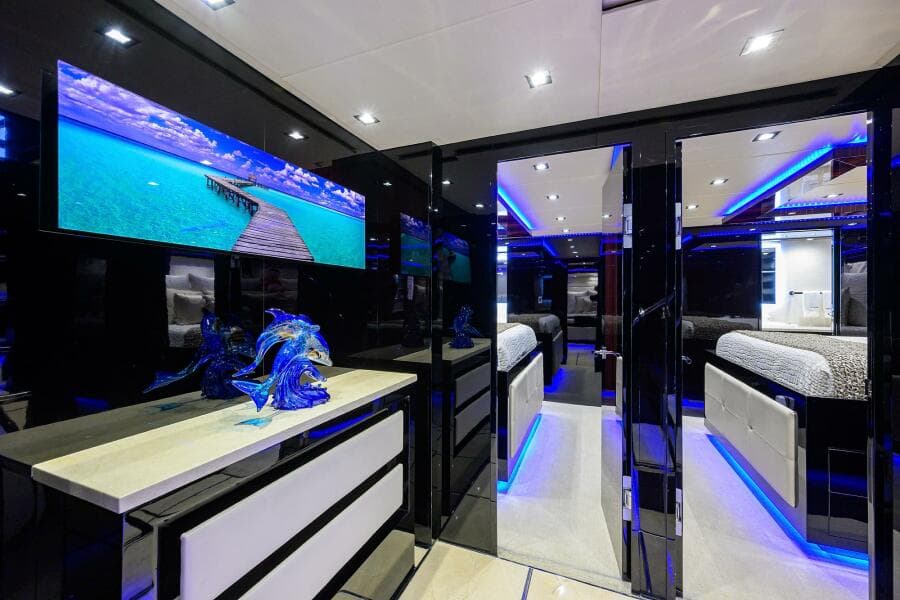 Luxurious interior of 1997 Broward 108 Raised Pilothouse yacht with modern decor and blue LED lighting.