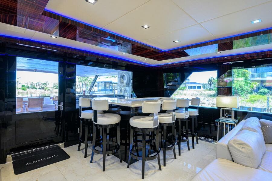 Luxurious interior of 1997 Broward 108 Raised Pilothouse yacht with modern bar area.