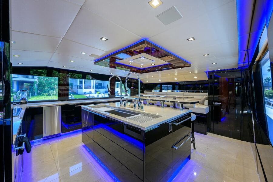 Luxurious kitchen interior of 1997 Broward 108 Raised Pilothouse yacht with modern lighting.