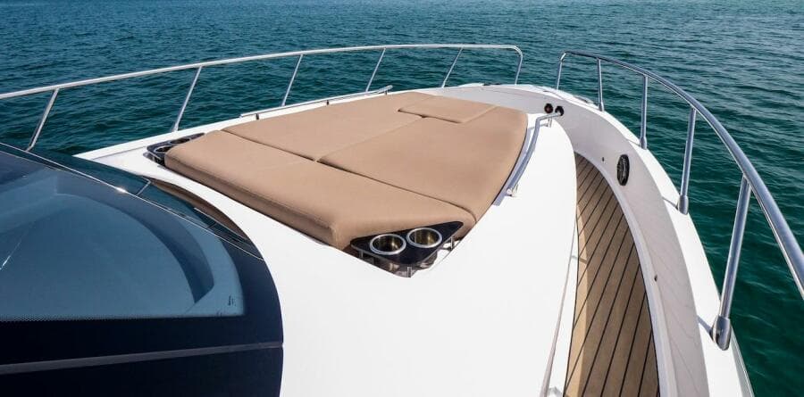 2024 Oryx 379 yacht with sunbathing area on deck, cruising on open water.
