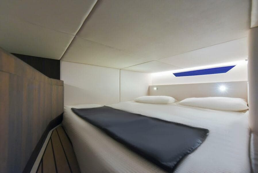 Luxurious cabin interior of 2024 Oryx 379 yacht with modern bedding and ambient lighting.