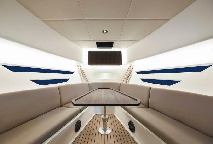 Luxurious interior of the 2024 Oryx 379 boat with elegant seating and wooden table.