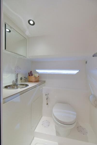 Modern bathroom in 2024 Oryx 379 boat with sleek white design.