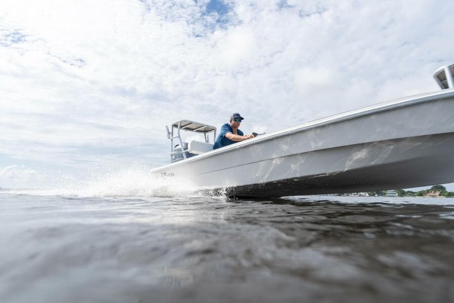 2025 BlueZones Boatworks 16' Flats skiff cruising on open water.