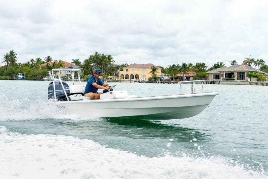 2025 BlueZones Boatworks 16' Flats cruising on a scenic waterway.