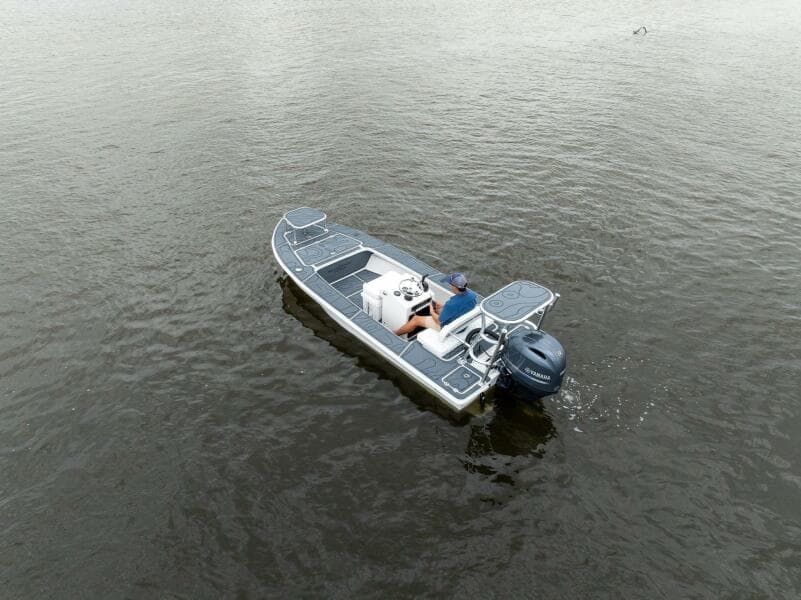 2025 BlueZones Boatworks 16' Flats boat on calm water, aerial view.