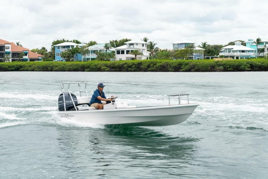 2025 BlueZones Boatworks 16' Flats cruising on a scenic waterway.